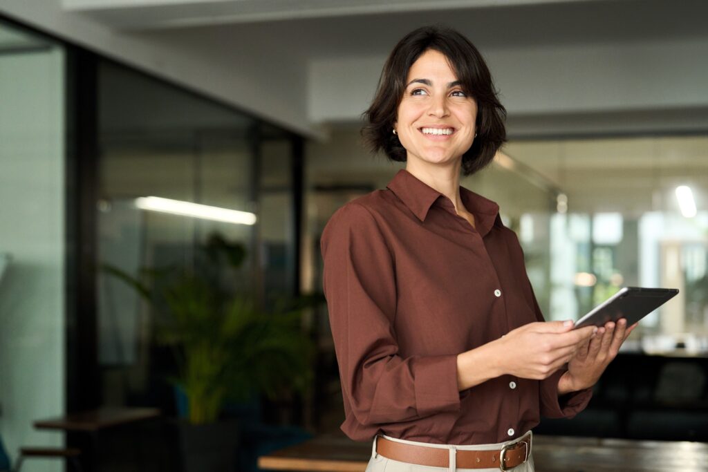 Happy,Young,Hispanic,Professional,Business,Woman,Using,Tab,Standing,In